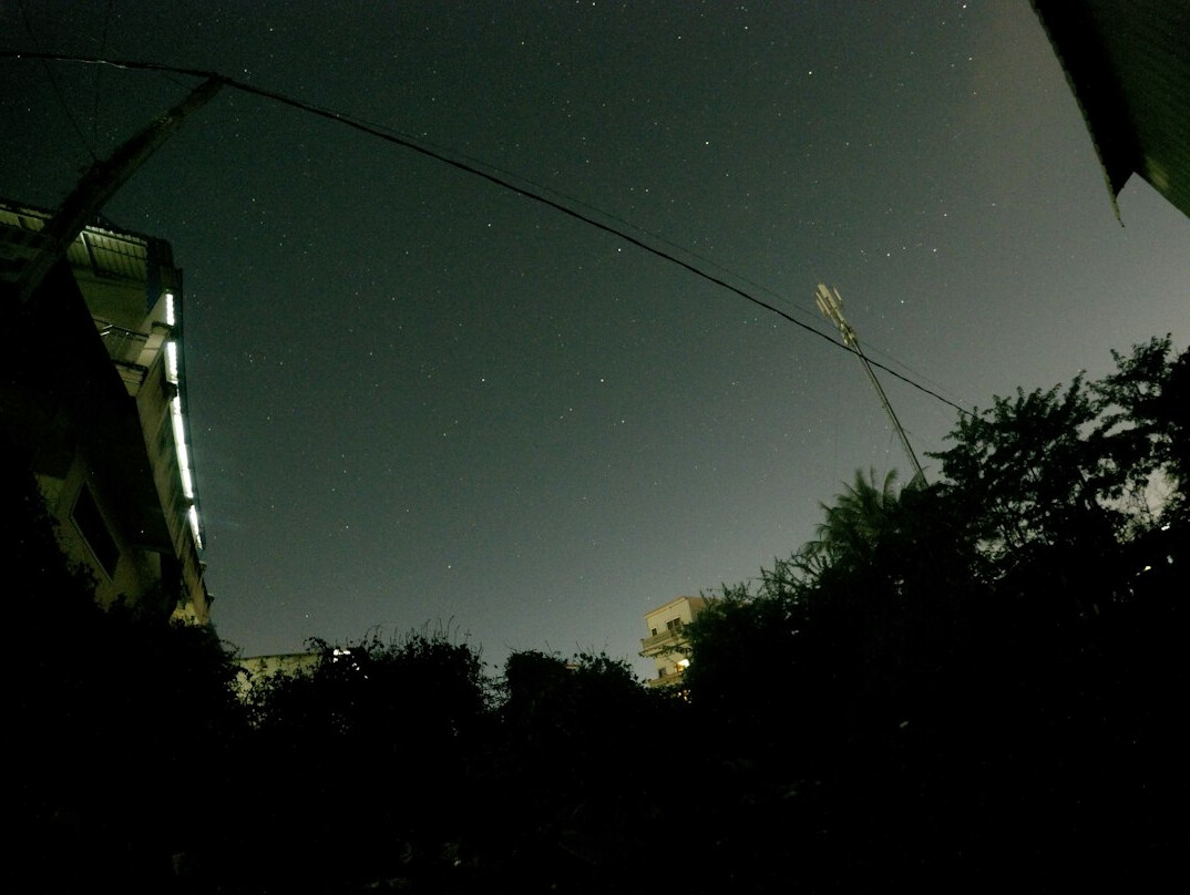 Outside broadcast compound with trucks and cables at night