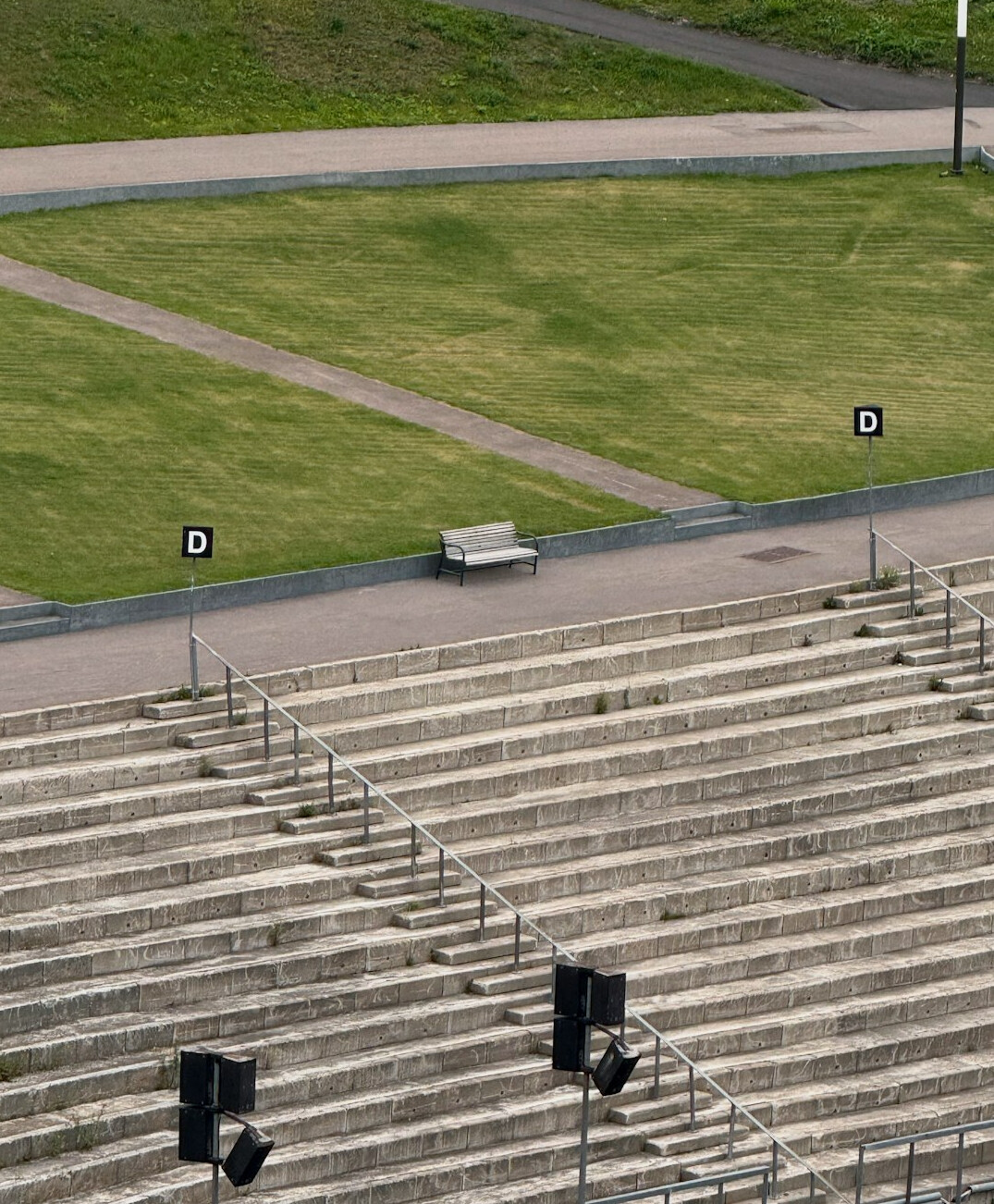 Camera operator filming from a stadium gantry before a football match