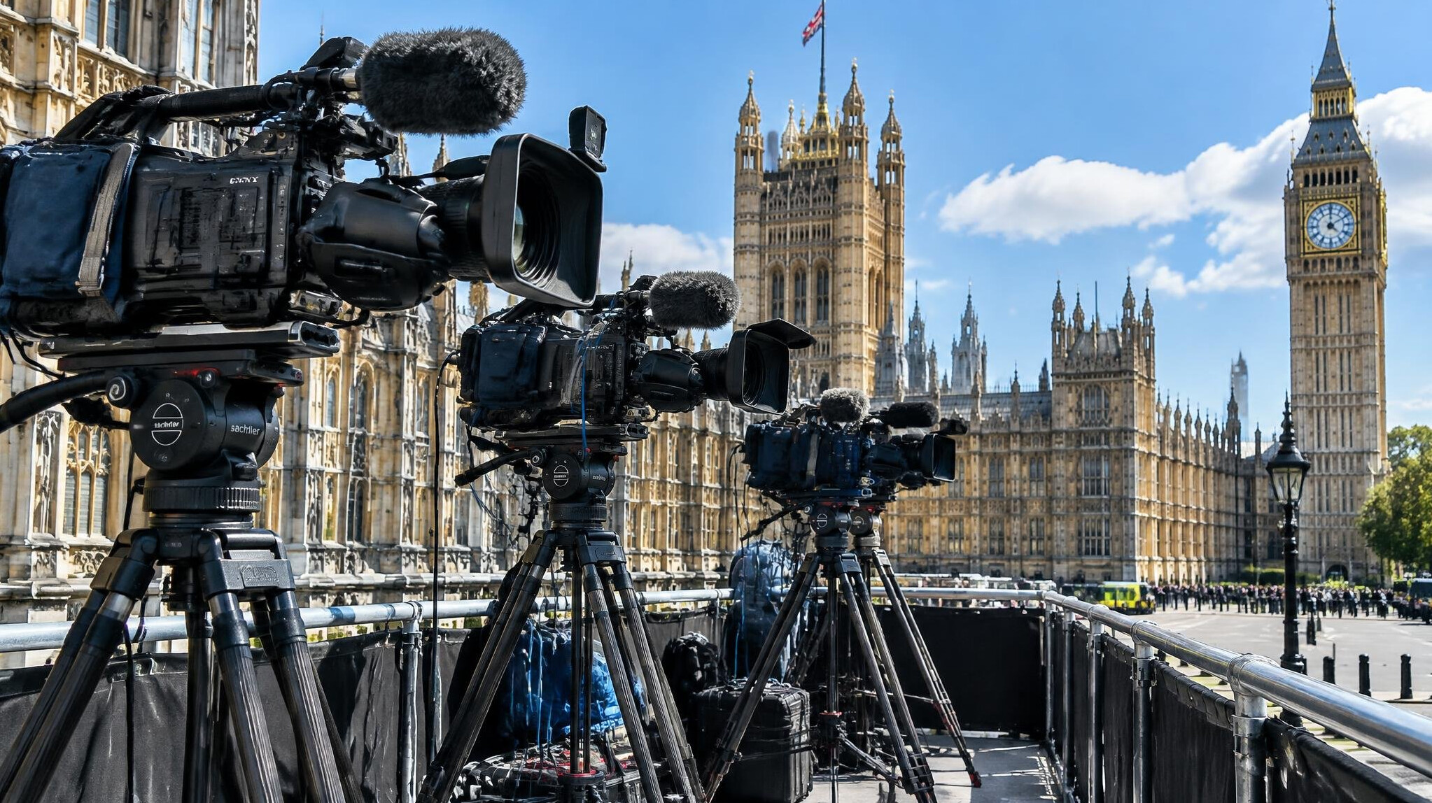 Multi-camera setup outside a palace gate on a sunny day
