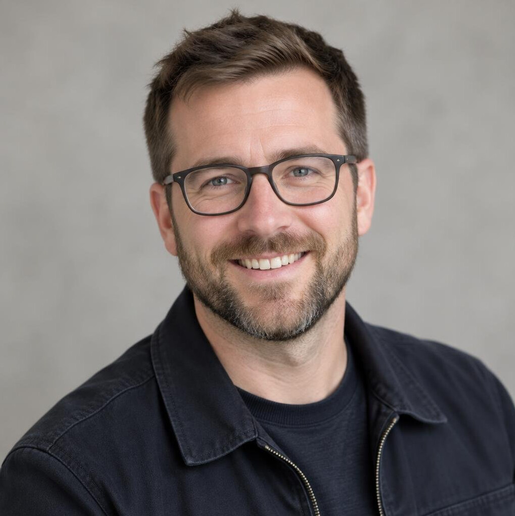 Studio portrait of a man with glasses and a beard
